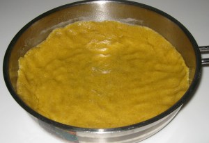press semolina dough in the pan 